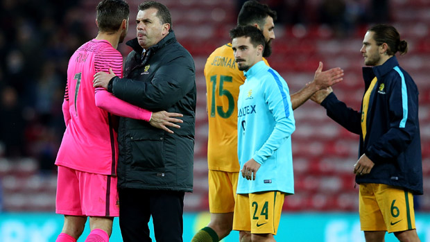 Ange Postecoglou embraces Maty Ryan following Australia's 2-1 loss to England.