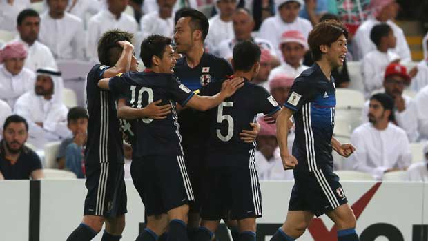 Japan players celebrate a goal in their win over UAE.