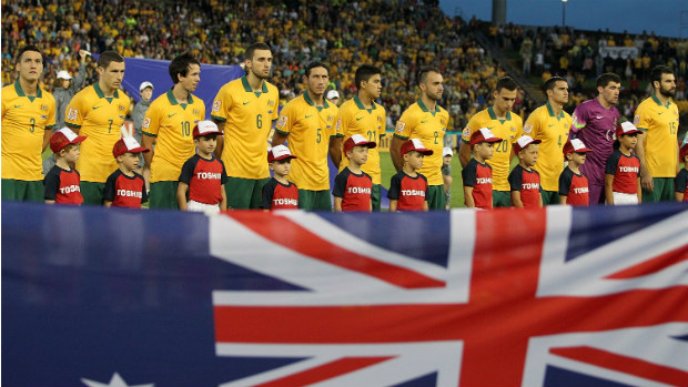 The Socceroos starting XI against the UAE sing the national anthem before kick-off.