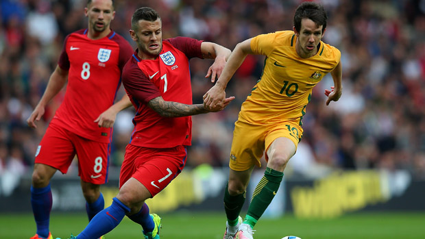Robbie Kruse controls the ball in front of Jack Wilshere.
