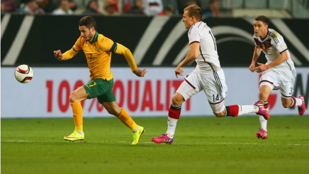 Socceroo Mathew Leckie darts away from Germany's defence.
