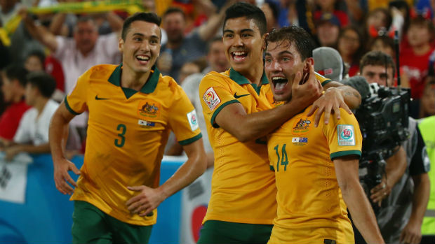 Adelaide-born Socceroos attacker James Troisi celebrates his winner in the Asian Cup final with Jason Davidson and Massimo Luongo.