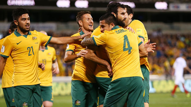 Socceroos players celebrate after Mile Jedinak opened the scoring from the penalty spot.