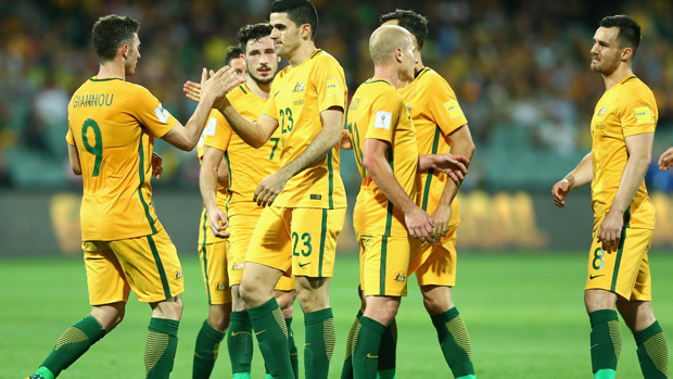 Caltex Socceroos players celebrate a Tom Rogic goal against Tajikistan.
