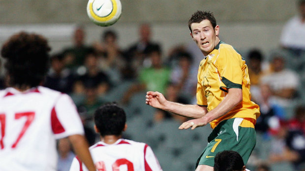 Brett Emerton flies high to win the ball against Indonesia in Perth in 2005.