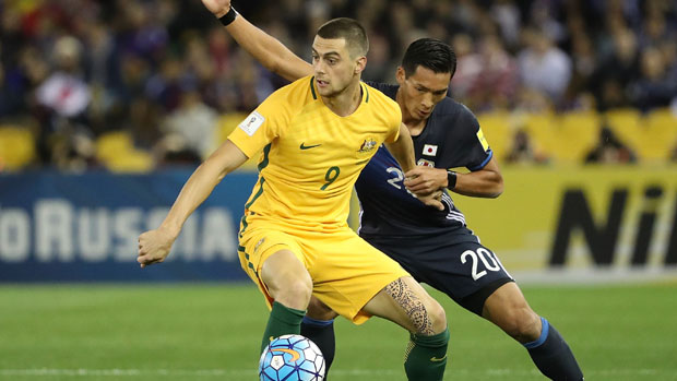 Tomi Juric fights off the attention of Japanese defender Tomoaki Makino.