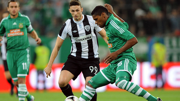 Paok Thessaloniki's Apostolos Giannou (L) vies for the ball with Rapid Vienna's Gerson (R) in the UEFA Europa League in 2012.