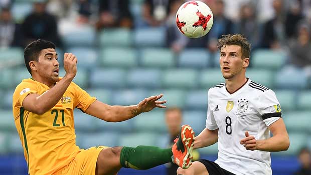 Caltex Socceroos midfielder Massimo Luongo fights for the ball with Germany's Leon Goretzka.