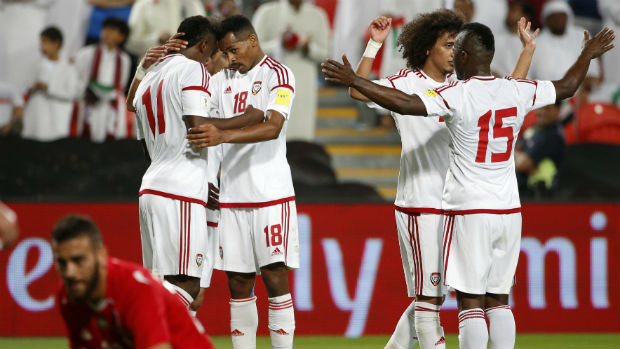 UAE players celebrate scoring against Palestine in World Cup qualifying.