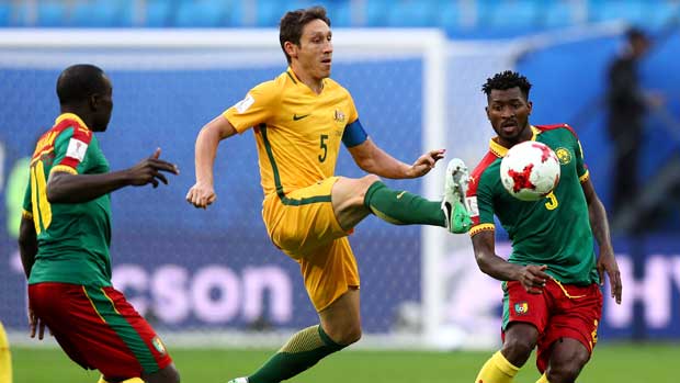 Skipper Mark Milligan beats two defenders to the ball to win possession for the Caltex Socceroos.