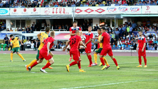 Mile Jedinak scores in the opening minute from a free-kick against Kyrgyzstan.