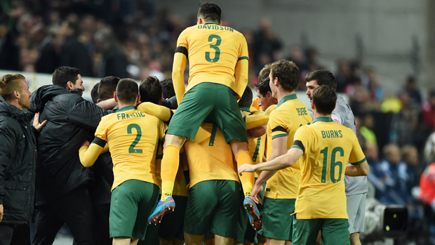 Socceroos players celebrate Mile Jedinak's goal against Germany.