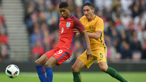 England's Marcus Rashford fights for the ball with Socceroos midfielder Mark Milligan.
