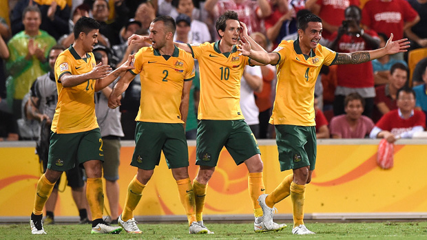 Socceroos players celebrate one of Tim Cahill's goals against China PR.