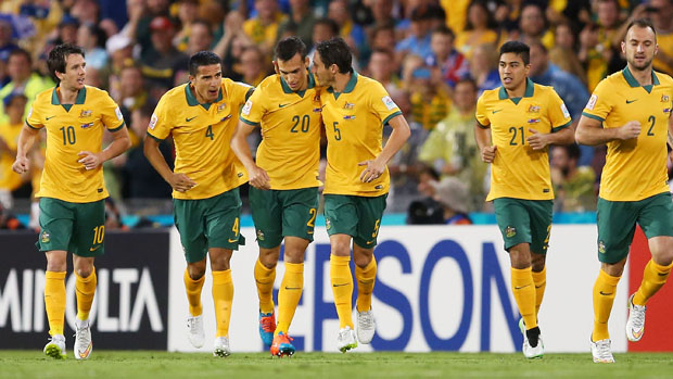 Socceroos players celebrate an early goal against UAE.