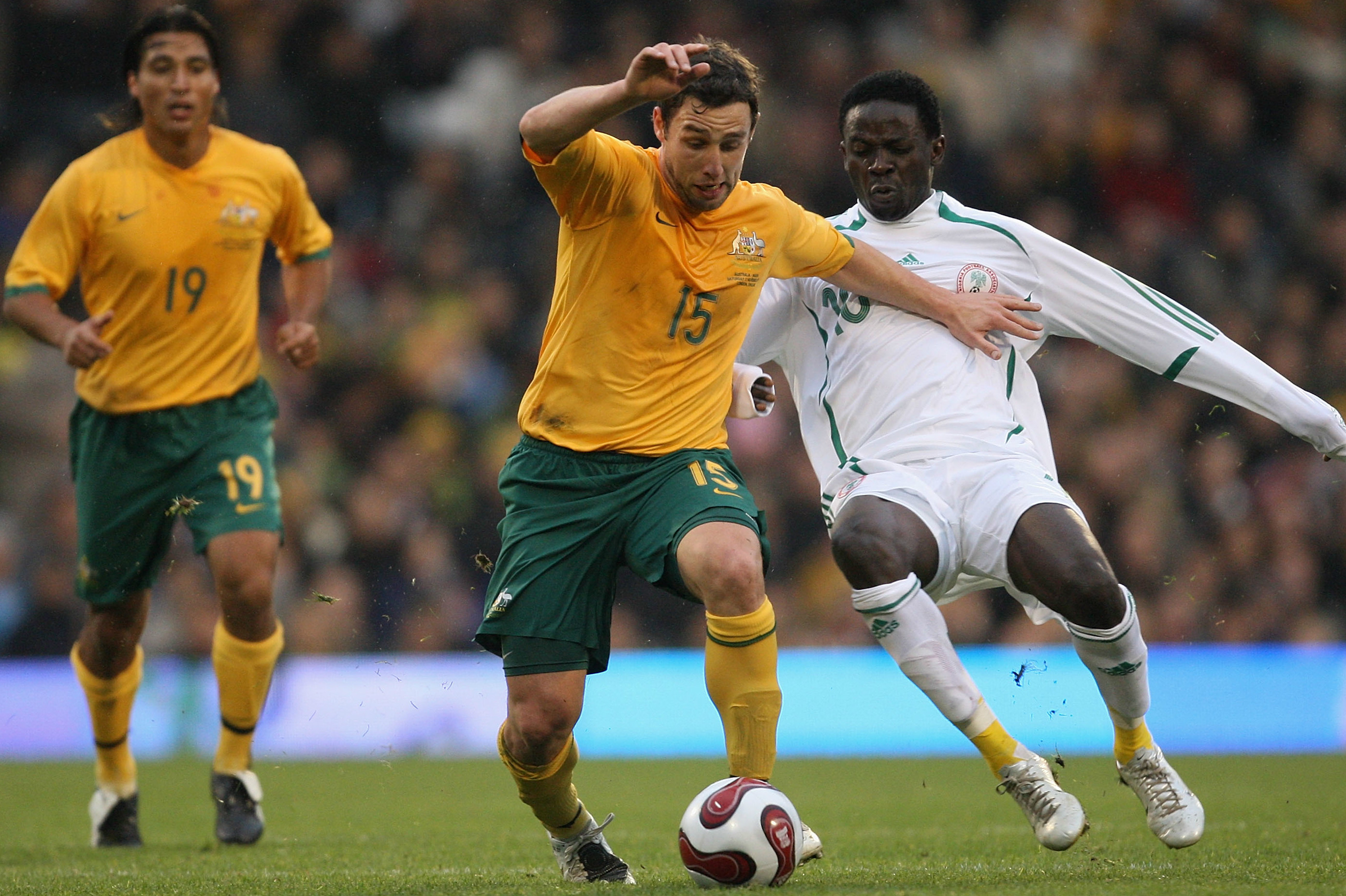 Scott McDonald holds off a Nigerian defender. Scott McDonald holds off a Nigerian defender.