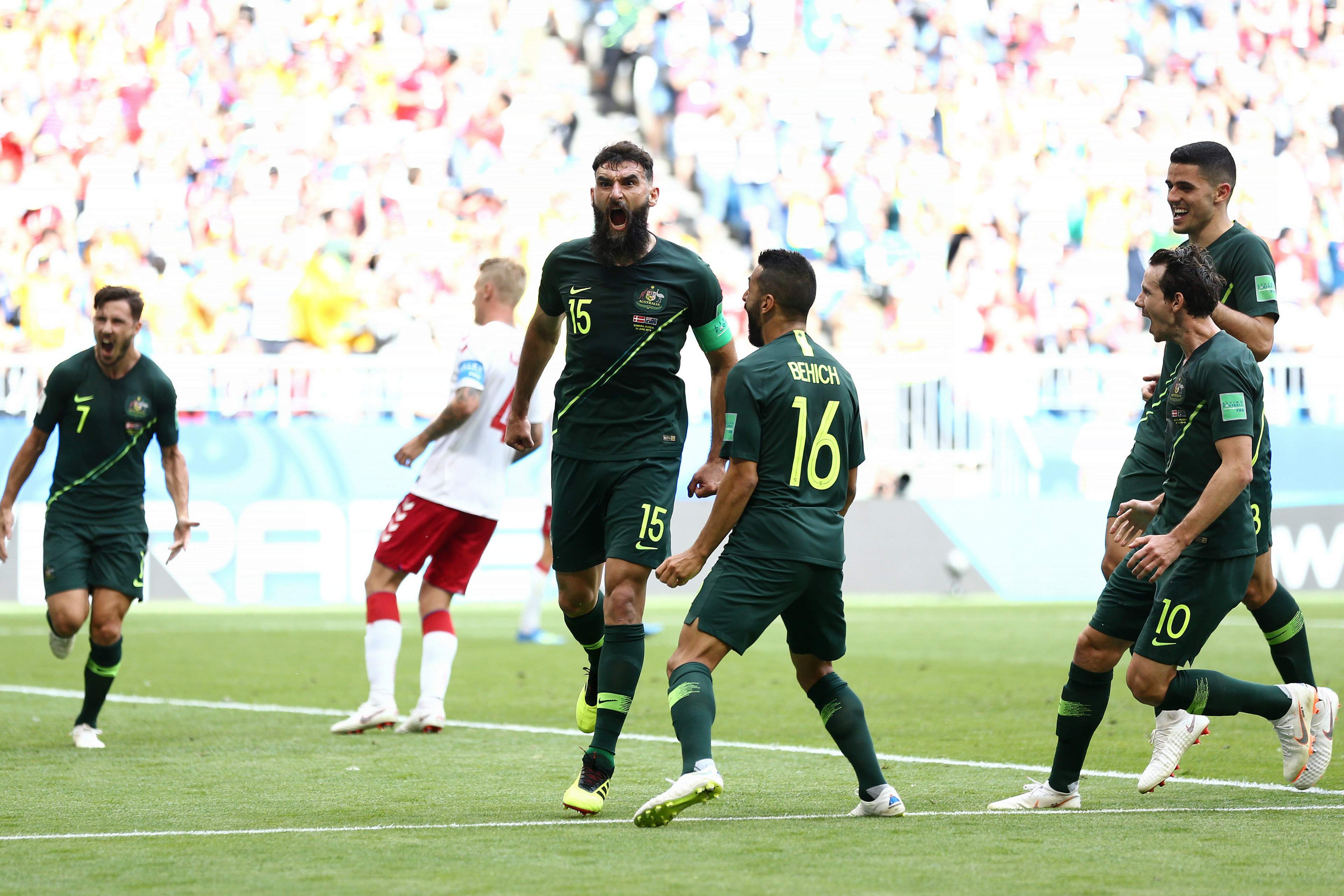 The Socceroos get around skipper Mile Jedinak after his penalty. The Socceroos get around skipper Mile Jedinak after his penalty.