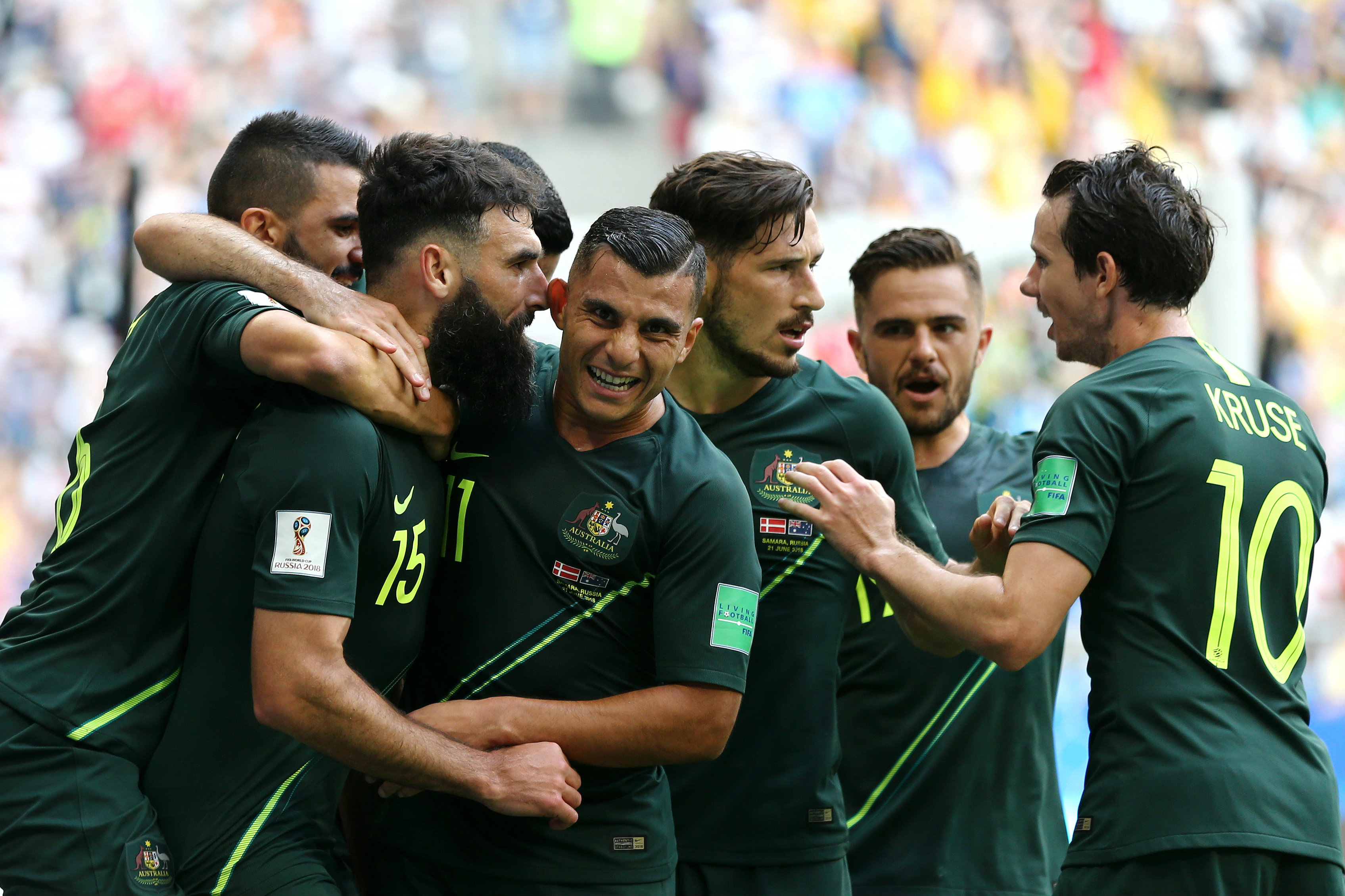 Australian players get around Mile Jedinak after his goal. Australian players get around Mile Jedinak after his goal.