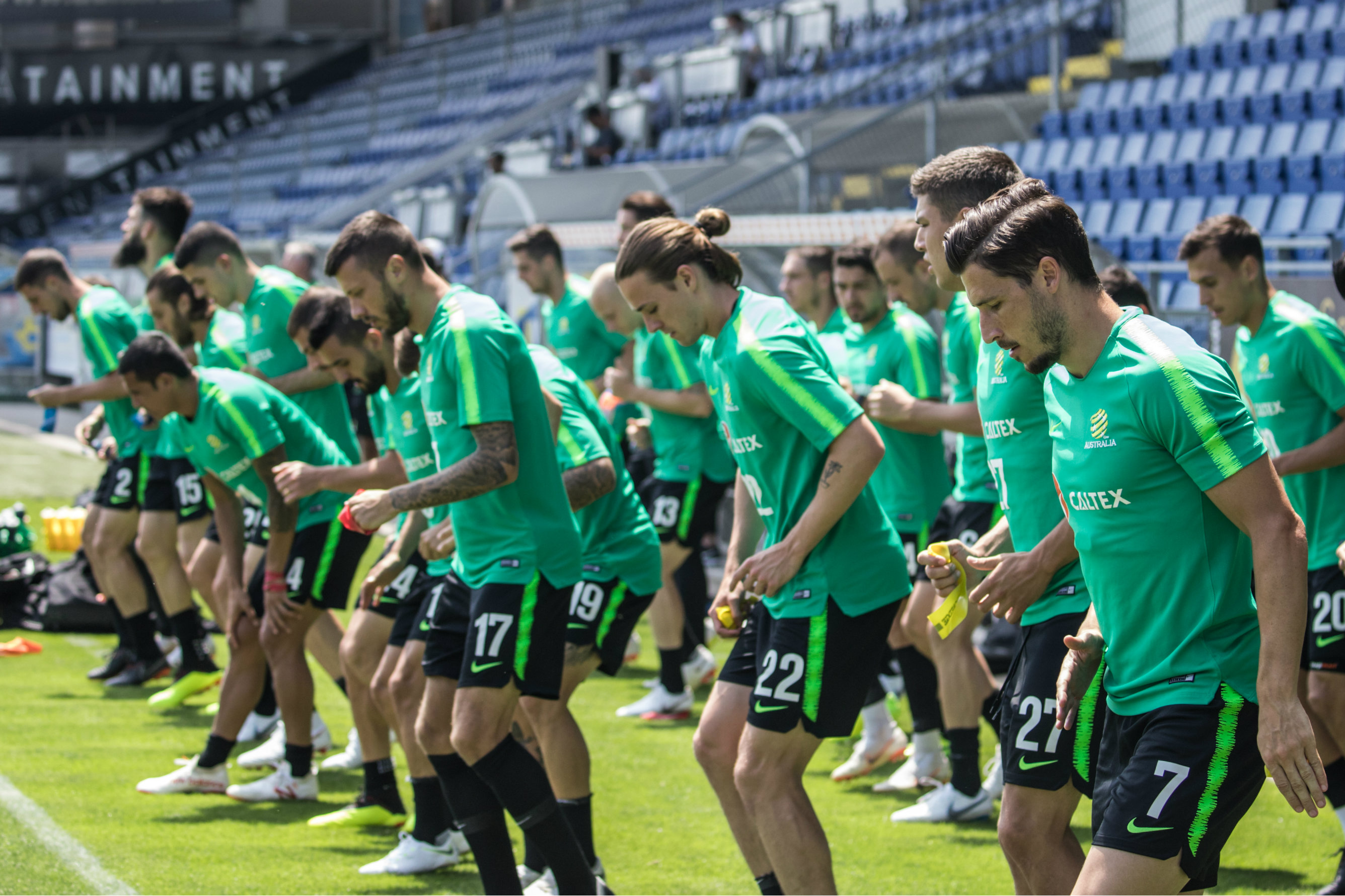 The Caltex Socceroos warm up before starting training. The Caltex Socceroos warm up before starting training.