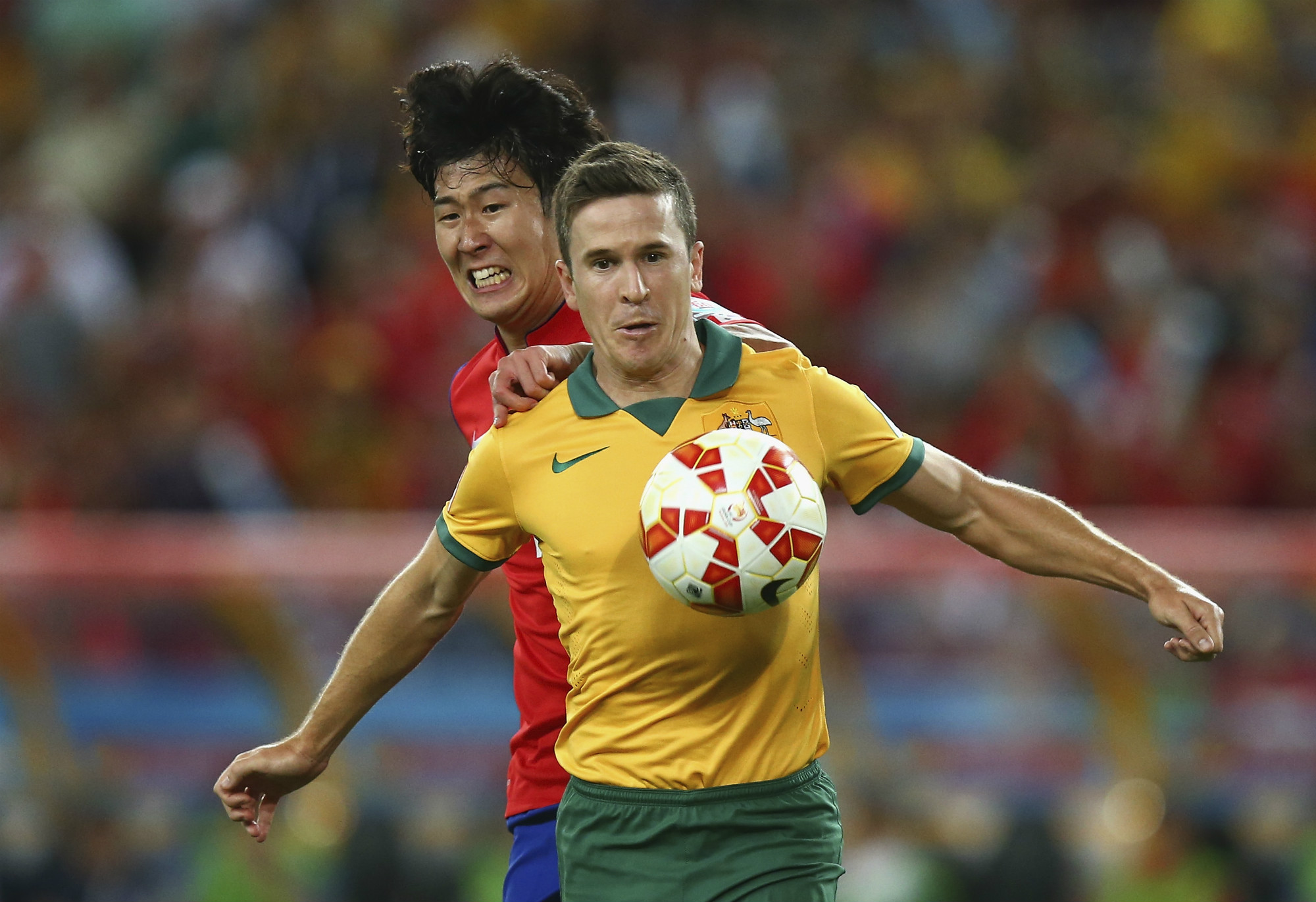 Matt McKay, playing for the Caltex Socceroos, is pressured by Son Heung-min Matt McKay, playing for the Caltex Socceroos, is pressured by Son Heung-min
