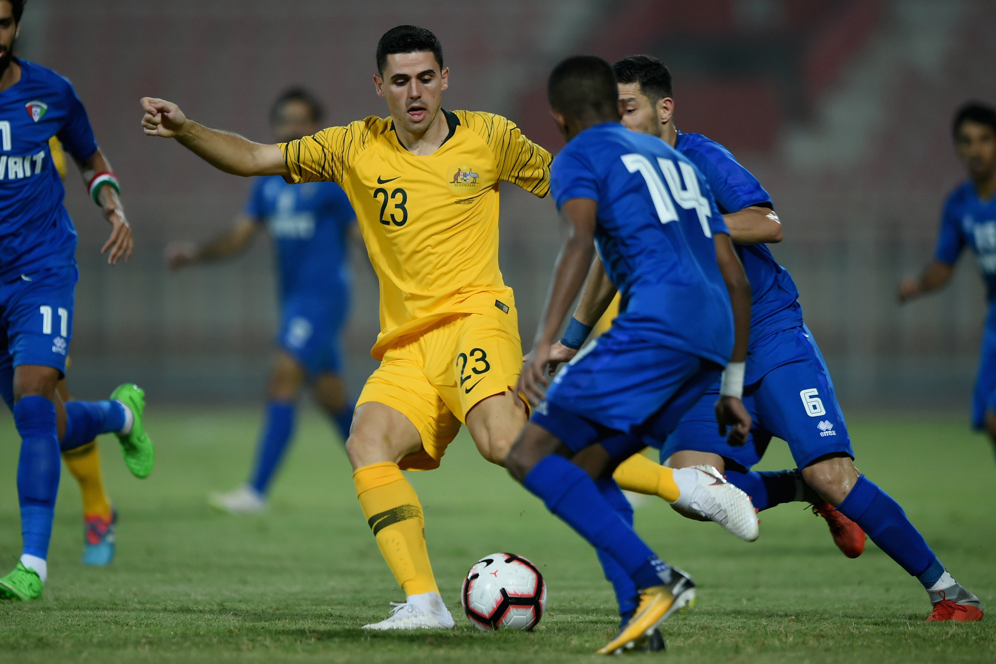 Tom Rogic tries to wriggle free of a couple of Kuwait defenders. Tom Rogic tries to wriggle free of a couple of Kuwait defenders.