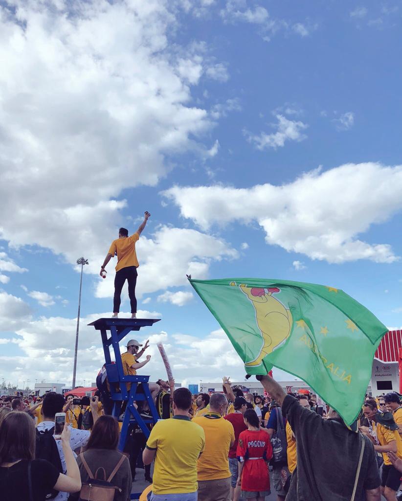 An Aussie stands above many Aussie fans leading chants An Aussie stands above many Aussie fans leading chants
