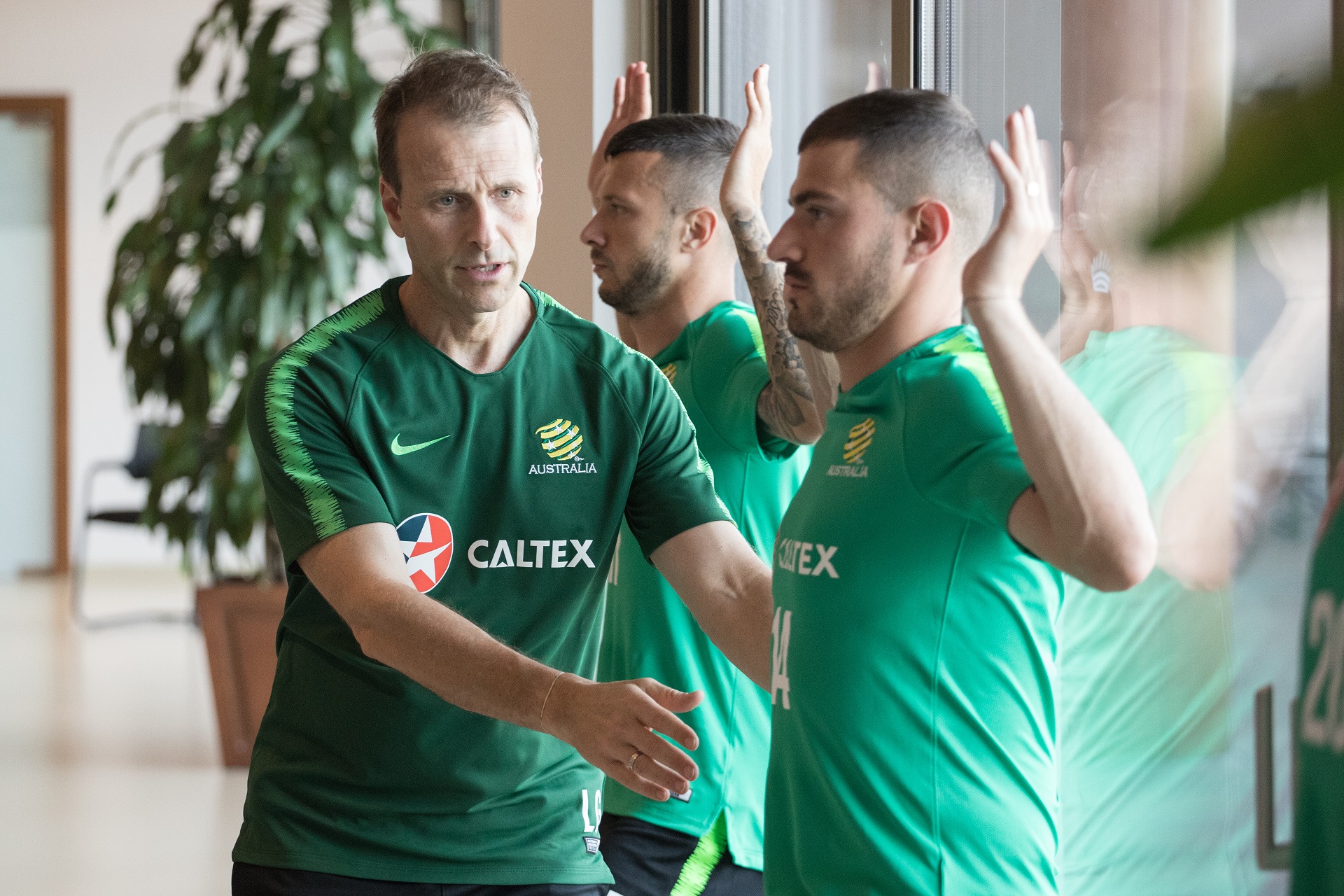 Socceroos physio Les Gelis as players did core and balance exercises
