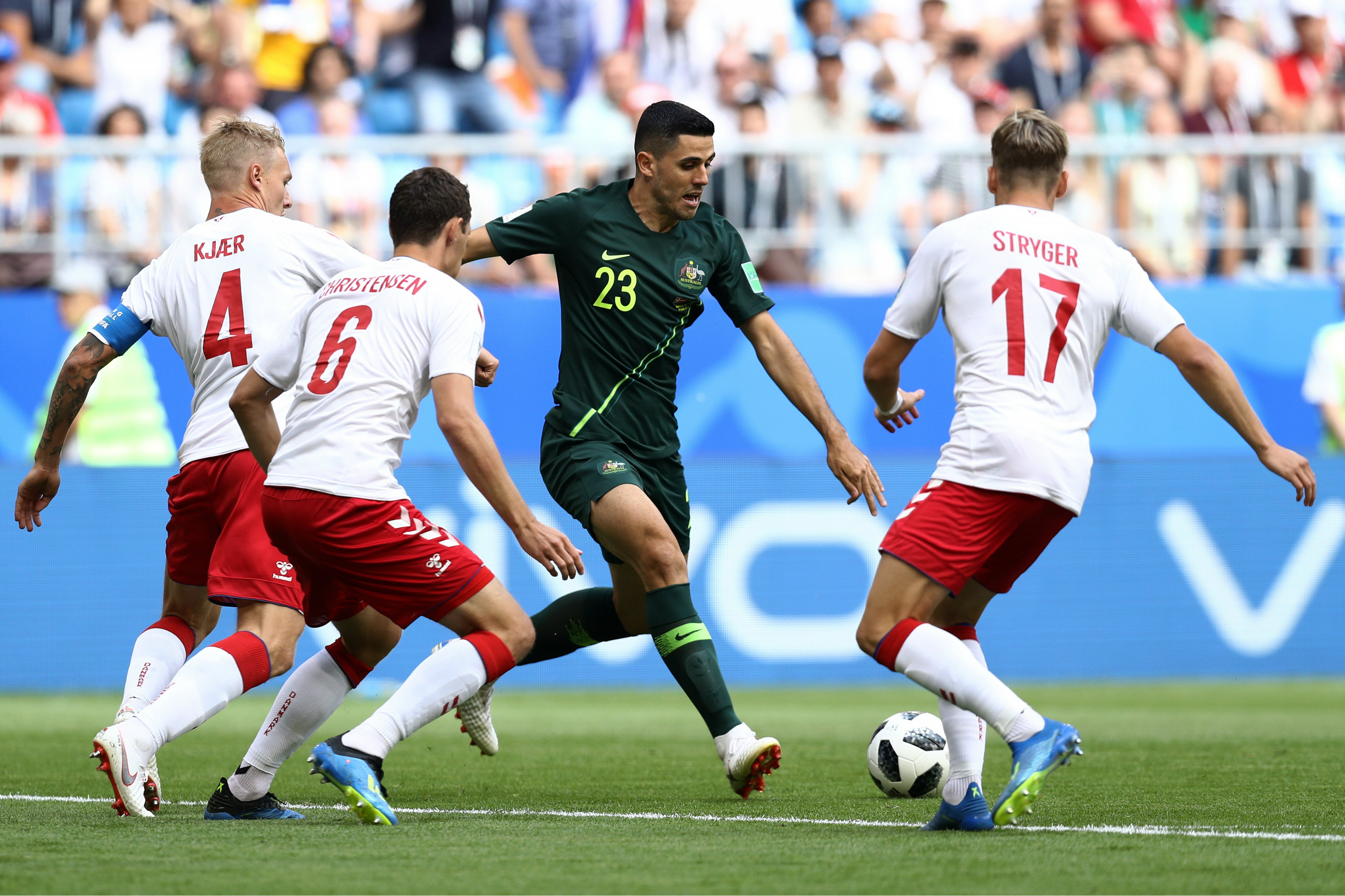 It takes three Danish defenders to try and stop Tom Rogic. 