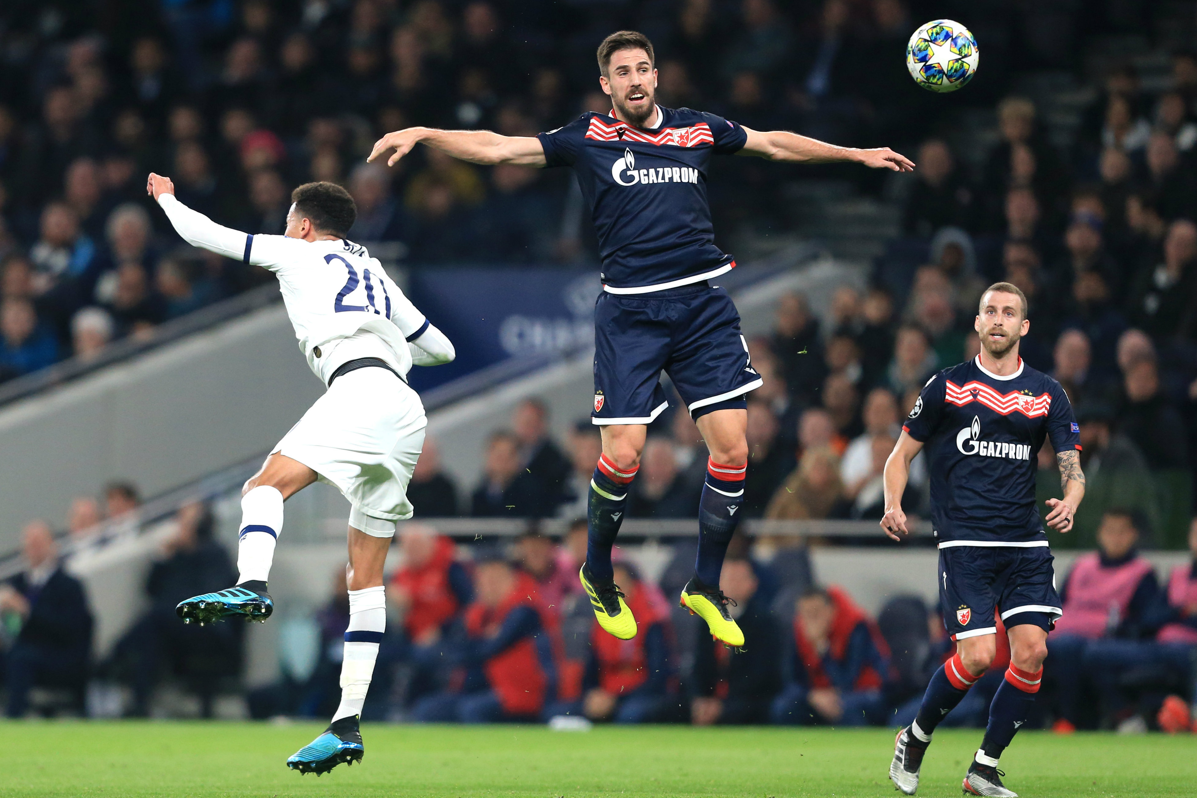 Milos Degenek challenges for a header with Tottenham's Dele Alli