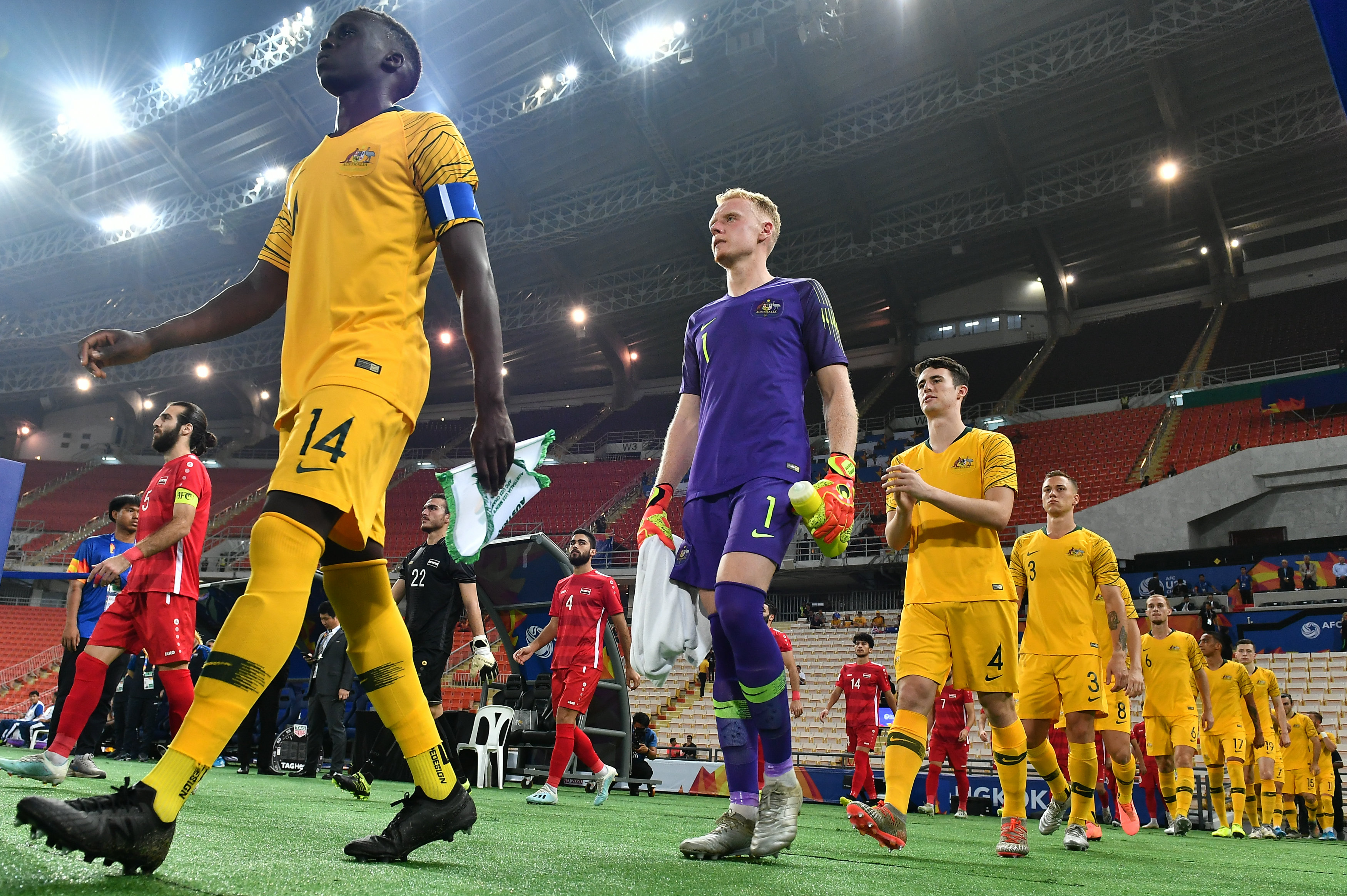 Thomas Deng leads out Australia in the quarter-final against Syria