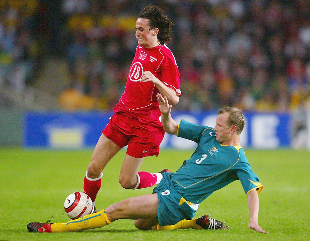 Steve Laybutt of Australia tackles Tuncay Sanli of Turkey during the Australia v Turkey friendly international soccer match as part of the 2006 World Cup preparations at Aussie Stadium May 21, 2004