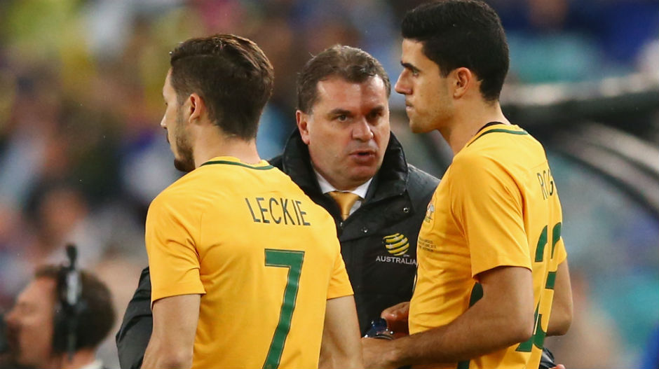 Caltex Socceroos coach Ange Postecoglou gives some instructions to substitutes Tom Rogic and Mat Leckie.