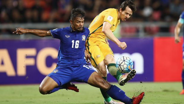 Robbie Kruse is tackled by Thailand's Prathum Chuthong in Tuesday night's WCQ.