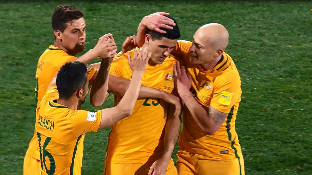Australian players celebrate Tom Rogic's stunning strike in the Socceroos' 3-2 win over Saudi Arabia.