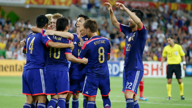 Japan celebrate Shinji Kagawa scoring their second goal against Jordan.