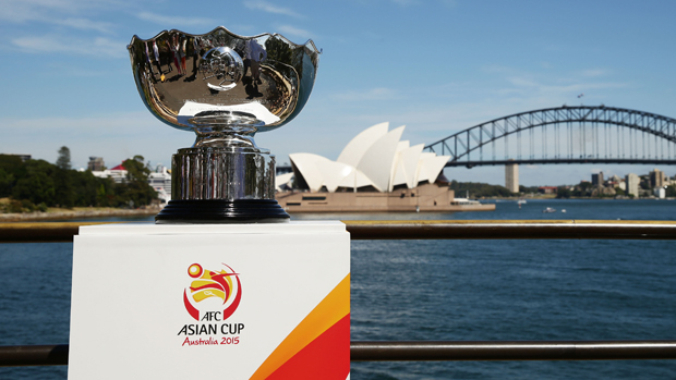 The Asian Cup trophy is modelled in front of the Sydney Opera House.