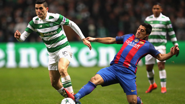 Tom Rogic is challenged by Barcelona superstar Luis Suarez in the UEFA Champions League.