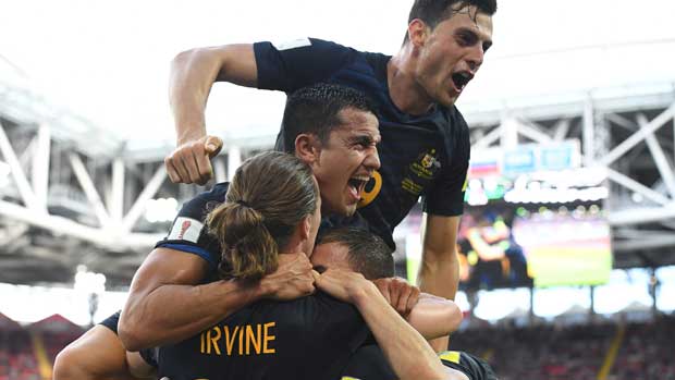 Tim Cahill celebrates with teammates after James Troisi opened the scoring against Chile in Moscow.