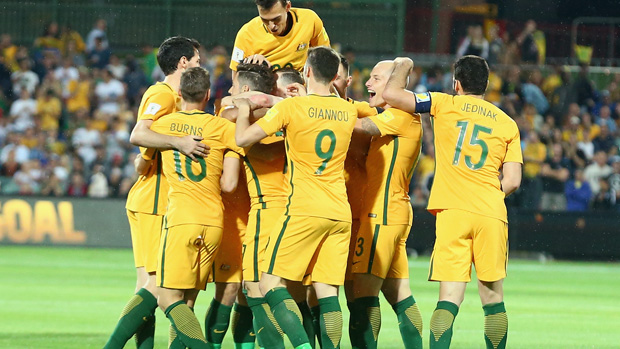 Socceroos players celebrate Massimo Luongo's early strike against Tajikistan.