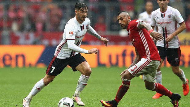 Mat Leckie takes on Bayern Munich's Arturo Vidal in the Bundesliga.