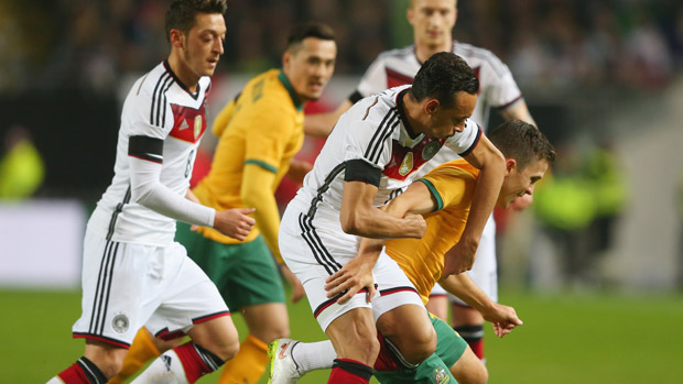 Socceroo midfielder Matt McKay fights for the ball against Germany.