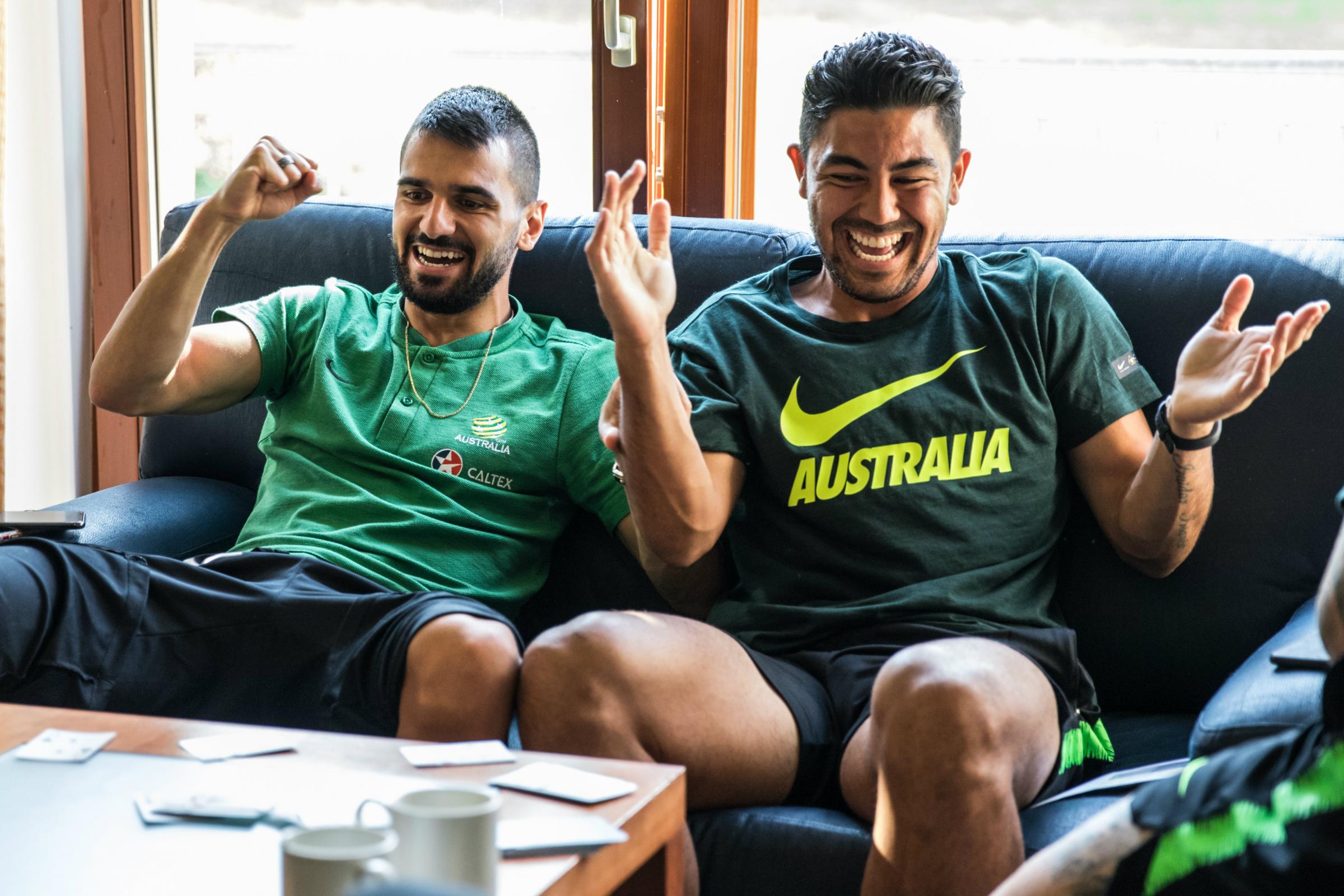 Aziz Behich and Massimo Luongo enjoy a game of cards in the team hotel.