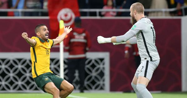 Aziz Behich celebrates with Andrew Redmayne after the Socceroos secured World Cup qualification