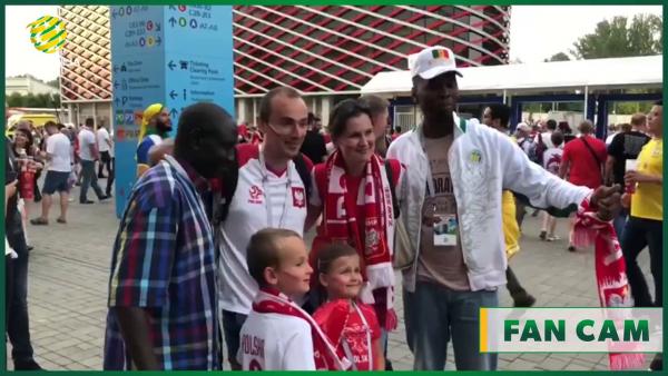 Senegalese and Polish fans take photos together post game