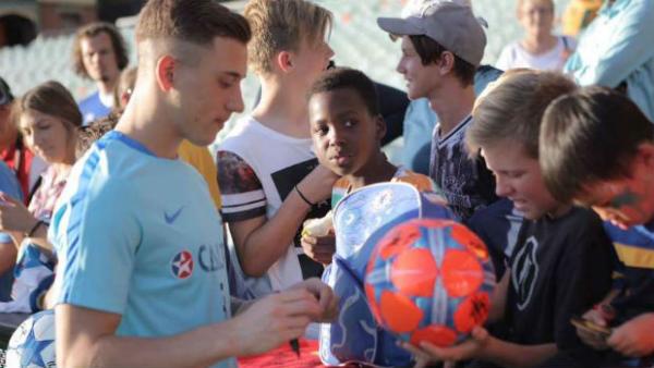 Defender Alex Gersbach sign autographs at the Caltex Socceroos' Fan Day in Adelaide.