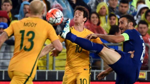 Robbie Kruse comes close to copping a boot to face from Greece midfielder Vassilelos Torosidis.