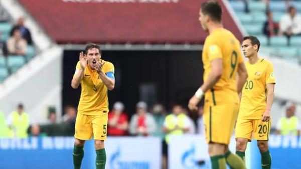Caltex Socceroos skipper Mark Milligan tries to urge his side on in the second half.