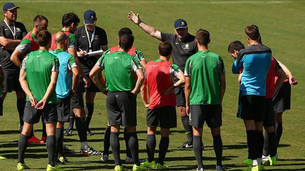 Coach Ange Postecoglou gives instructions to his Socceroos side on the training ground.