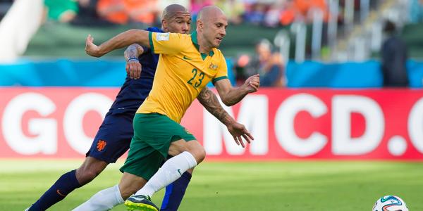 Bresciano challenges for the ball with Holland's Nigel De Jong.