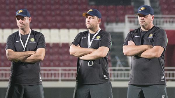The Socceroos coaching staff monitor training in Doha.